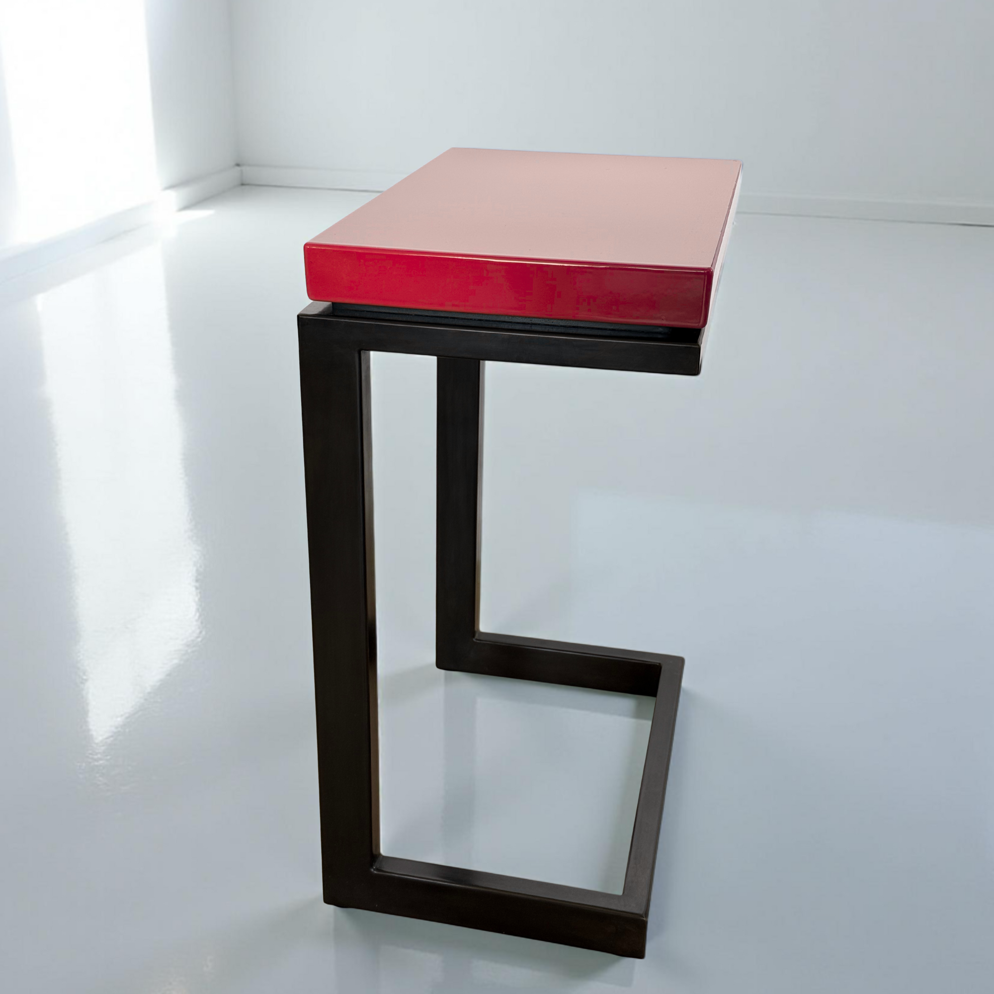 Modern laptop table featured in Heartthrob Red porcelain enamel with blued steel base.